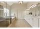 Luxurious bathroom featuring double vanity, soaking tub, and glass-enclosed shower at 214 Cedar Woods Way, Canton, GA 30114