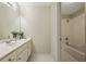 Cozy bathroom featuring a white vanity, a large mirror, and access to a shower-tub combo at 214 Cedar Woods Way, Canton, GA 30114