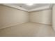 Spacious bedroom featuring neutral carpet, recessed lighting, and a tray ceiling at 214 Cedar Woods Way, Canton, GA 30114