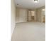 Large, carpeted bedroom area with access to multiple doorways and a view of the staircase at 214 Cedar Woods Way, Canton, GA 30114