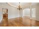 Dining room features hardwood floors, detailed trim, and access to kitchen at 214 Cedar Woods Way, Canton, GA 30114