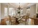 Dining room with hardwood floors, detailed trim, large windows, and dining table with seating at 214 Cedar Woods Way, Canton, GA 30114