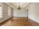 Spacious dining room features hardwood floors, detailed trim, and a modern chandelier at 214 Cedar Woods Way, Canton, GA 30114