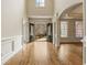 Expansive foyer with hardwood floors, an arched doorway, and a view of the landscaped front yard through the double doors at 214 Cedar Woods Way, Canton, GA 30114