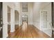 Grand two-story foyer with hardwood floors, archways, and white trim, offering a stunning first impression at 214 Cedar Woods Way, Canton, GA 30114