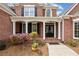 Close-up view of the home's entrance featuring a double door entry and well-maintained landscaping at 214 Cedar Woods Way, Canton, GA 30114