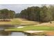 Scenic golf course view highlighting lush green grass, sand traps, trees, and a tranquil pond at 214 Cedar Woods Way, Canton, GA 30114