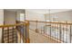 Hallway with wooden railing and view of the living area and staircase at 214 Cedar Woods Way, Canton, GA 30114