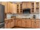 Close up of the kitchen with wood cabinetry, granite counters and stainless appliances at 214 Cedar Woods Way, Canton, GA 30114