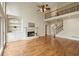Stunning living room features a fireplace, hardwood floors, and access to the upper level at 214 Cedar Woods Way, Canton, GA 30114