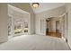Bright and airy living room featuring a bay window, neutral carpet, and a doorway leading to another room at 214 Cedar Woods Way, Canton, GA 30114