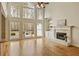 Beautiful living room features a cozy fireplace, built-in shelving, and backyard views at 214 Cedar Woods Way, Canton, GA 30114