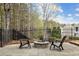 Cozy outdoor patio with stone firepit and seating, perfect for entertaining and enjoying the outdoors at 214 Cedar Woods Way, Canton, GA 30114