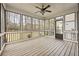 Inviting screened porch with wood flooring, ceiling fan, and views of the wooded backyard at 214 Cedar Woods Way, Canton, GA 30114