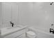 Clean bathroom with white tiles, quartz countertop and updated fixtures at 7043 Foundry Dr, Woodstock, GA 30188