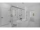 A stunning primary bath features a glass shower, soaking tub, and marble floors at 7043 Foundry Dr, Woodstock, GA 30188