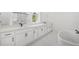 A bathroom with double vanities and a soaking tub at 7043 Foundry Dr, Woodstock, GA 30188