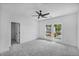 Bedroom featuring ample natural light with windows offering views of the landscaped front yard at 7043 Foundry Dr, Woodstock, GA 30188