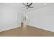 Bright bedroom featuring hardwood floors, a ceiling fan, and double French doors leading to another room at 7043 Foundry Dr, Woodstock, GA 30188