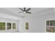 A spacious bedroom with a modern ceiling fan and abundant natural light from multiple windows at 7043 Foundry Dr, Woodstock, GA 30188