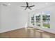 Spacious bedroom with hardwood floors, ample natural light from large windows, and ceiling fan at 7043 Foundry Dr, Woodstock, GA 30188