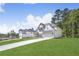 Charming two-story home with a pristine lawn and a concrete driveway leading to an attached two car garage at 7043 Foundry Dr, Woodstock, GA 30188