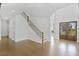 Bright, open foyer boasts hardwood floors, a striking staircase, and elegant double doors leading outside at 7043 Foundry Dr, Woodstock, GA 30188