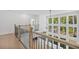 Bright foyer with hardwood floors, white walls, and large windows overlooking the landscaped yard at 7043 Foundry Dr, Woodstock, GA 30188