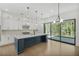 Modern kitchen with an island, stainless steel appliances, and sliding doors to the patio at 7043 Foundry Dr, Woodstock, GA 30188