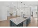 Bright kitchen featuring an island with sink, white countertops, and modern lighting at 7043 Foundry Dr, Woodstock, GA 30188