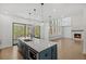 Stylish kitchen with a large island, stainless appliances, and sliding glass doors to the outdoors at 7043 Foundry Dr, Woodstock, GA 30188