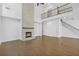 Open living room with stone fireplace, wood floors, and stairway to the second floor at 7043 Foundry Dr, Woodstock, GA 30188