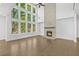 Inviting living room featuring hardwood floors, a stone fireplace, and stunning floor-to-ceiling windows at 7043 Foundry Dr, Woodstock, GA 30188