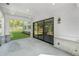 Covered patio featuring stone accents and views of the wooded backyard at 7043 Foundry Dr, Woodstock, GA 30188