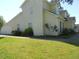 A shot of the exterior of the home showing the attached garage and partial view of the backyard at 1174 Oak Knoll Ct, Lithonia, GA 30058
