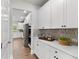 Butler Pantry features white cabinets, grey subway tile backsplash and white countertops at 3710 Near Star Ln, Cumming, GA 30028