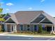 Exterior of the community clubhouse featuring a covered entry, ample parking and manicured landscaping at 3710 Near Star Ln, Cumming, GA 30028