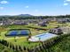 Aerial view of the community pool, tennis courts, playground, clubhouse and surrounding homes at 3710 Near Star Ln, Cumming, GA 30028