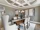 Elegant dining room features coffered ceiling, chandelier, and modern furniture on hardwood floors at 3710 Near Star Ln, Cumming, GA 30028