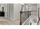 Upstairs hallway features neutral walls and carpet flooring with decorative railing at 3710 Near Star Ln, Cumming, GA 30028