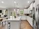 Modern kitchen with stainless steel appliances, island with seating, and hardwood floors at 3710 Near Star Ln, Cumming, GA 30028