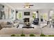 Bright living room features a fireplace, ceiling fan and hardwood floors with plenty of natural light at 3710 Near Star Ln, Cumming, GA 30028