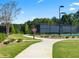 A peaceful walking trail through the Briarwood community with lush green grass and mature trees at 3710 Near Star Ln, Cumming, GA 30028