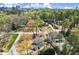 Aerial view of the neighborhood, showcasing lush greenery, mature trees and the proximity to city skyline at 495 Heritage Way, Atlanta, GA 30328