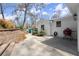 The backyard features a patio area perfect for outdoor grilling, next to the retaining wall with shrubbery at 495 Heritage Way, Atlanta, GA 30328