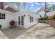 Home exterior featuring a concrete patio, white siding, and a red grill at 495 Heritage Way, Atlanta, GA 30328