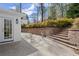 Beautiful backyard with stone retaining wall and steps up to a landscaped garden area at 495 Heritage Way, Atlanta, GA 30328