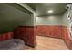 Finished basement space with wood paneling and a cozy pet bed area at 495 Heritage Way, Atlanta, GA 30328