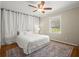 Cozy bedroom featuring a plush bed, soft rug, and ample natural light from the window at 495 Heritage Way, Atlanta, GA 30328