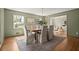 A dining room with a wood table, upholstered chairs, and natural light from the windows at 495 Heritage Way, Atlanta, GA 30328
